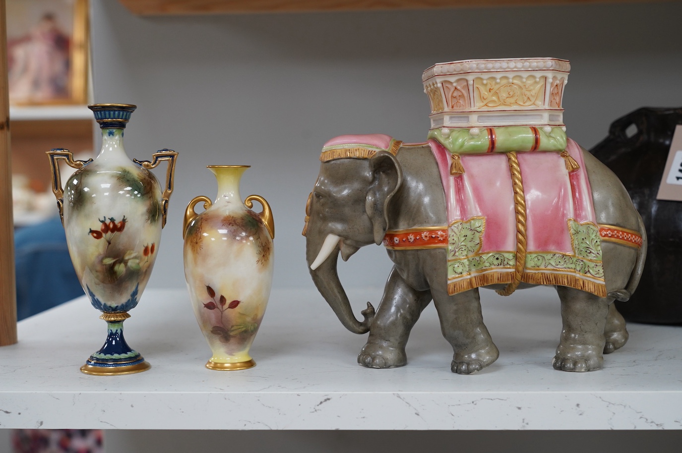 A Hadley's Worcester elephant with howdah and two Hadleys vases, peacock decoration, tallest 19.5cm. Condition - good